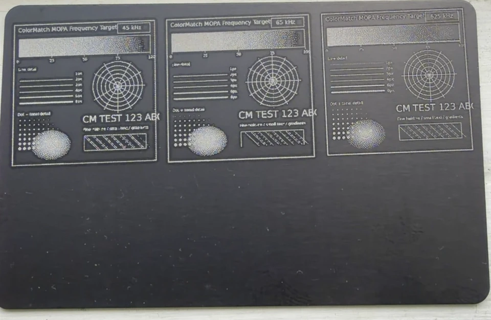 Black metal test card engraved with three ColorMatch test targets.